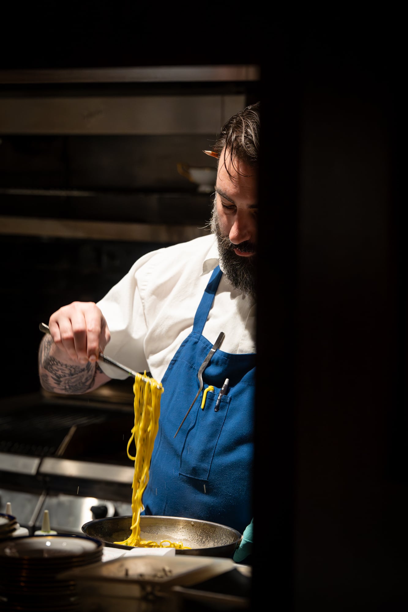 Chef lifting fresh pasta